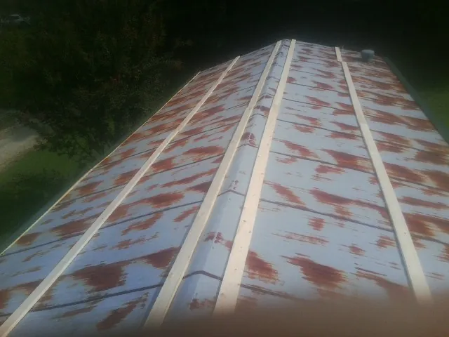 Rusted metal roof panels with new wood purlins before replacement — Storm Damage Roof Repair in Eagle by Roofing Brothers